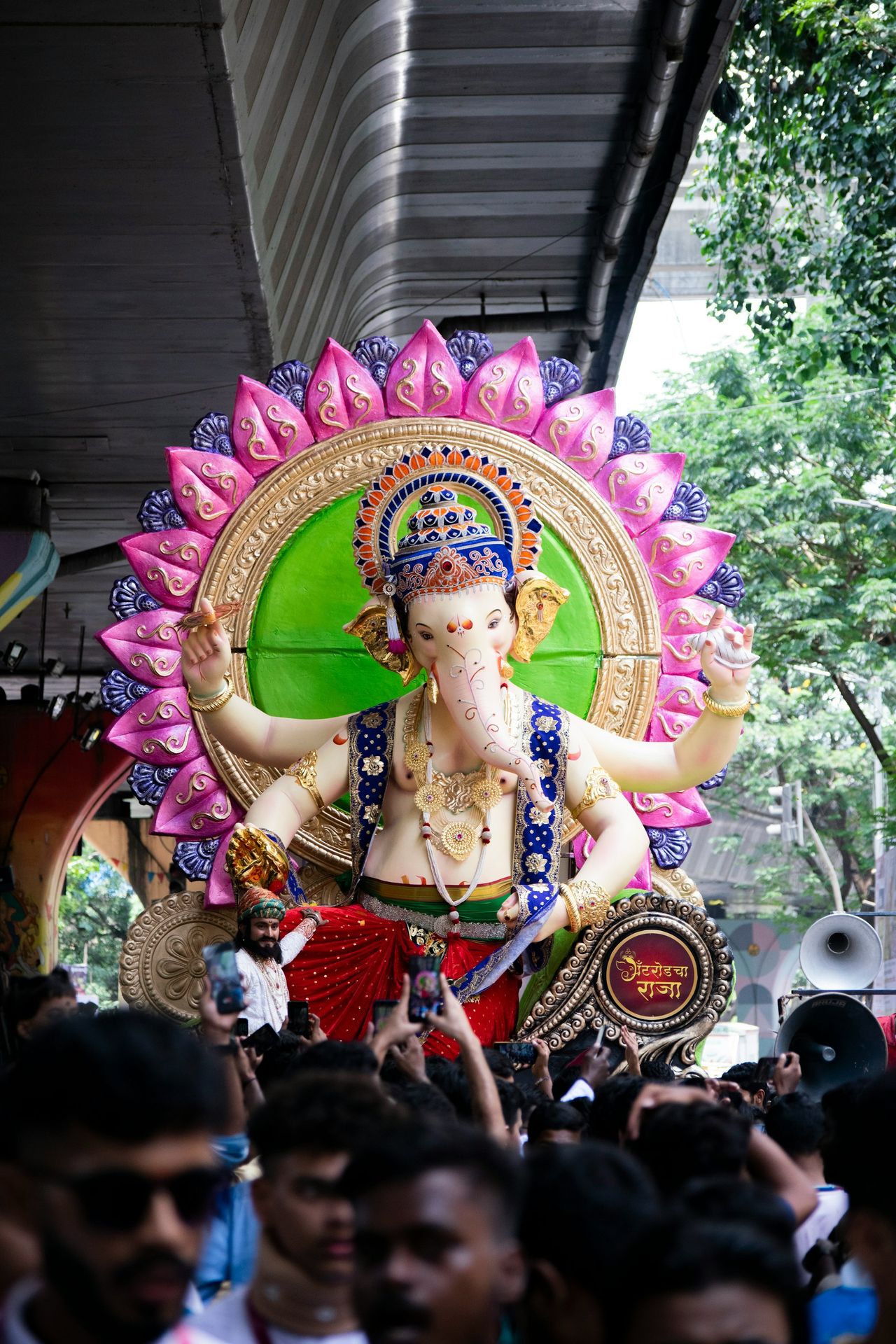 A crowd of people standing around a giant statue